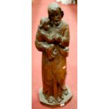 A large carved softwood figure of a father and child,