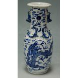 A Chinese export stoneware blue and white vase, with underglaze blue decoration depicting a dragon
