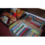 Four boxes of assorted childrens annuals, toys and games,