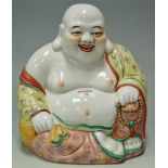 A large Chinese glazed stoneware figure of Buddha, enamel decorated with impressed seal mark