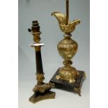 A gilt metal table lamp in the form of a classical ewer of a marble plinth,