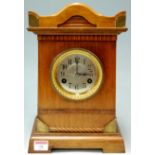 An early 20th century oak cased and brass mounted mantel clock,