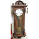 A late 19th century Vienna figured walnut cased droptrunk wall clock,