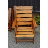 A set of four modern stained and slatted pine folding garden armchairs