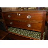 An Edwardian walnut two drawer dressing chest (lacking superstructure)