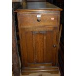 A pair of oak single door bedside cupboards,