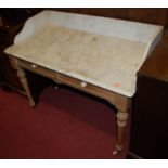 A Victorian pine and white variegated marble topped two drawer wash stand