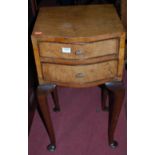 An early 20th century figured walnut serpentine front two drawer bedside table