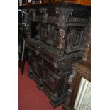 A late 19th century Flemish heavily carved oak court cupboard,