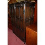 A James Reeve Ltd joined and panelled oak double door wardrobe in the 17th century style