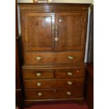 An antique joined oak housekeeper's cupboard, the upper section with twin doors over dummy drawer,