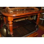 A Victorian mahogany round cornered extending dining table,