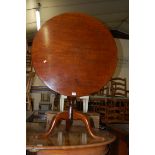 A 19th century mahogany circular tilt top tripod table