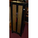 A Chinese ebonised and snakeskin effect inset double door side cupboard of tapering form