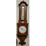 An early 20th century oak aneroid two dial wheel barometer