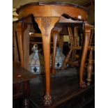 A walnut centre table raised on cabriole claw and ball supports
