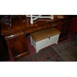 An early Victorian mahogany and flame mahogany scroll ledge back twin pedestal sideboard,