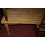 A large modern pine round cornered farmhouse kitchen table,