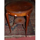 An Edwardian walnut circular occasional table, having a gadrooned edge,