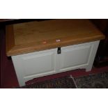 A modern light oak topped and white painted hinge top twin panelled blanket box