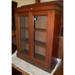 A Victorian walnut double door glazed bookcase