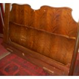 A super king size walnut framed bedstead comprising headboard, base board, and side rails