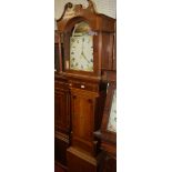 An early 19th century oak mahogany and crossbanded longcase clock, having a painted arch dial,