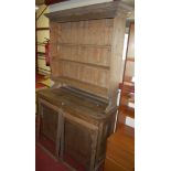 An Edwardian pine bookcase cupboard,