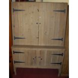 A planked pine four door side cupboard,