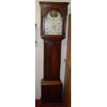 An early 19th century mahogany and satinwood strung longcase clock, having arched painted dial,