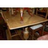 An Ercol mid-elm dining table;