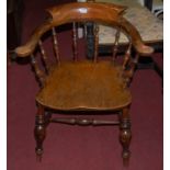 An early 20th century elm seat and beech Captain's chair