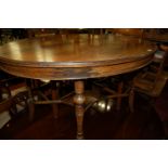 An Edwardian walnut oval topped centre table