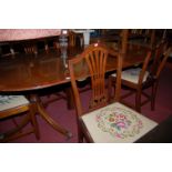 A reproduction mahogany twin pedestal dining table in the Regency style,