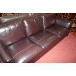 A contemporary dark brown leather three seater sofa