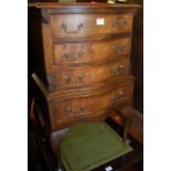 A small reproduction mahogany serpentine fronted four drawer bedside chest