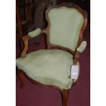 A pair of late 19th century Louis XV style carved walnut framed fauteuil;