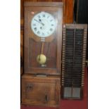 An early 20th century oak cased clocking-in and out machine by The Gledhillbrook Time Recorders Ltd,