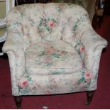 A Victorian walnut framed and floral buttonback upholstered tub chair
