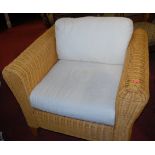 A pair of modern wicker conservatory armchairs,