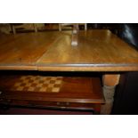 An Edwardian stained pine extending dining table,