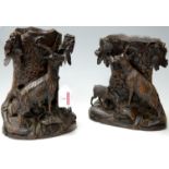 A pair of late 19th century Black Forest carved vases, each modelled as a hollowed tree stump with