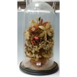 A Victorian glass dome containing woolwork display of flowers, h.