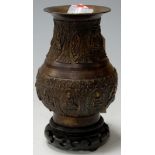 A Buddhist bronze temple vase, probably Tibetan, on ebonised plinth, h.17cm  Condition Report /