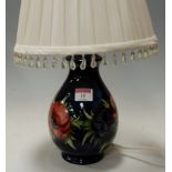 A Moorcroft Hibiscus pattern table lamp of baluster form,