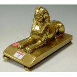 A Victorian brass doorstop in the form of an Egyptian sphinx