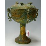 A far eastern gilt brass pedestal urn and cover with applied dragon decoration