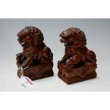 A pair of Chinese carved hardwood Fo dogs