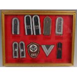 A framed and glazed display group of German Army shoulder boards and insignia to include 22nd