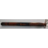 A 19th century turned wooden truncheon polychrome painted with the motto "Honi soit mal y pense,"